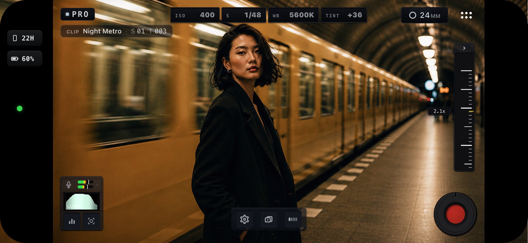MoviePro Pro mode in landscape framing a night metro scene — ISO, shutter, white balance and tint telemetry across the top, with clip slate, audio meters, luma scope and zoom rail.